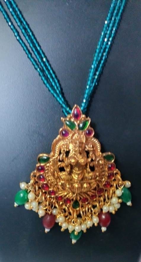 Traditional gold plated pendant necklace with intricate detailing and vibrant gemstones view 2