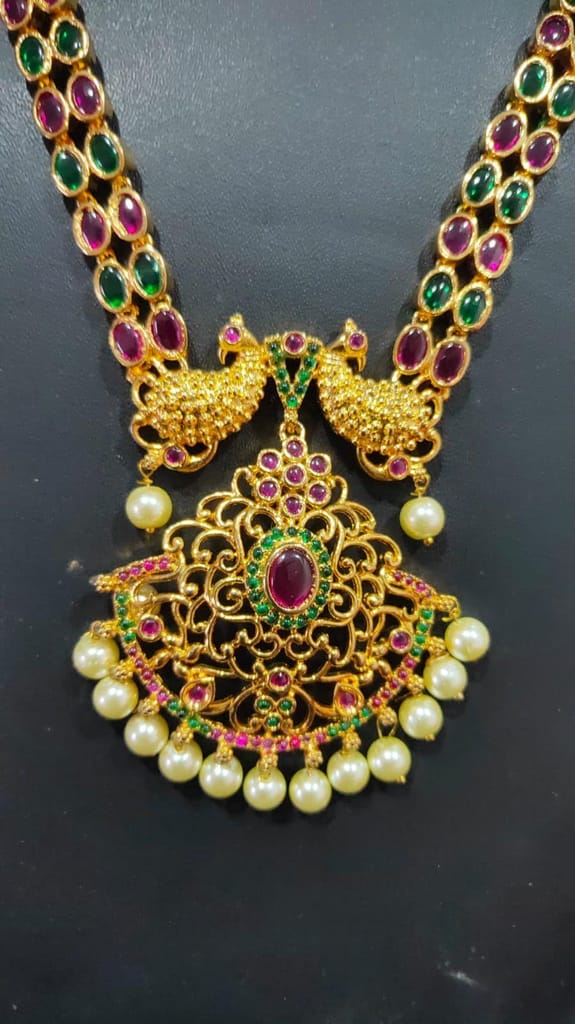 Gold-plated traditional Indian necklace and earring set with green stones and pearls view 2