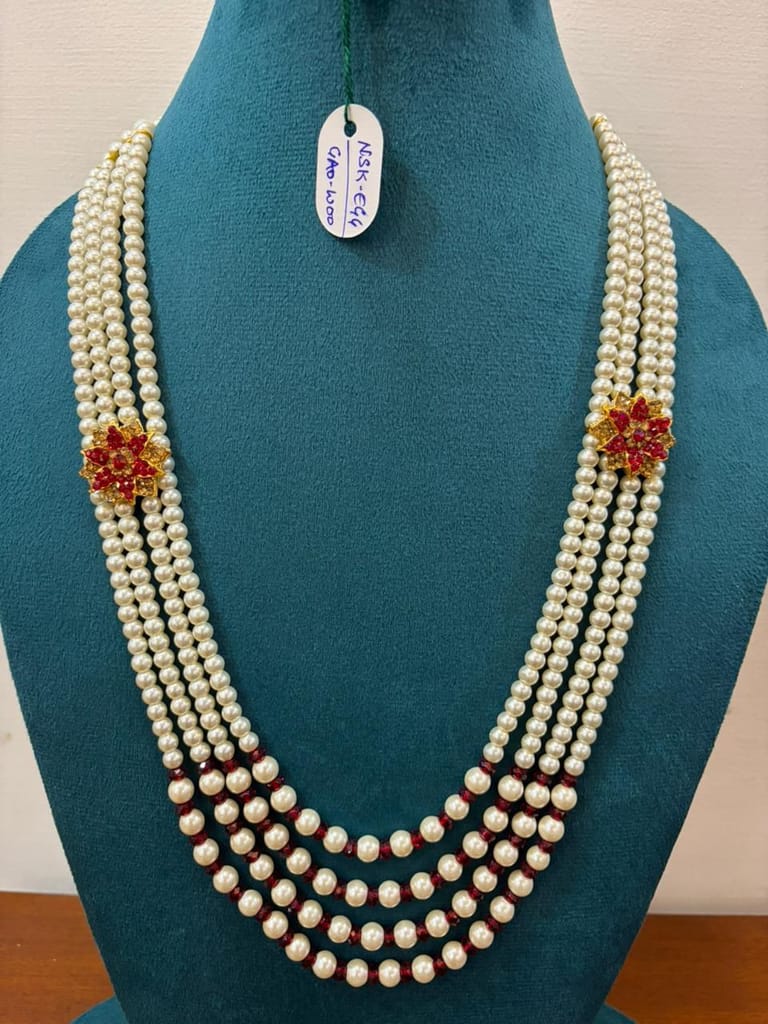 groom multi-strand white moti necklace featuring maroon pearl spacers and flower charm