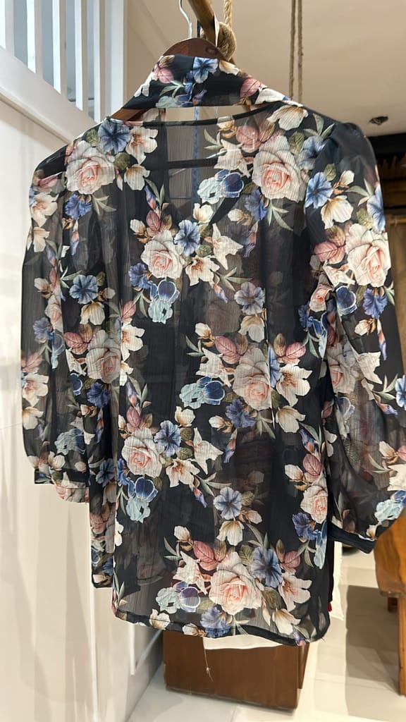 Semi-sheer black top with a flowy design Top view 2