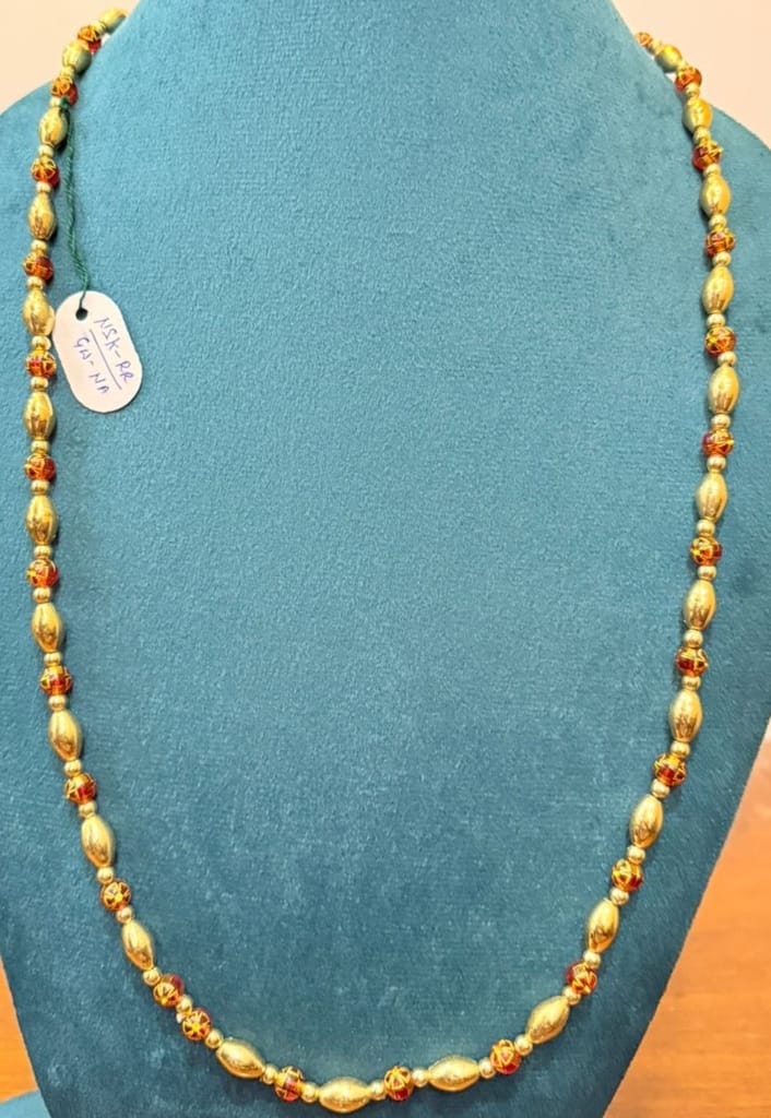 gold textured capsule beads sherwani jewelry with red contrast spacers in single strand view 2