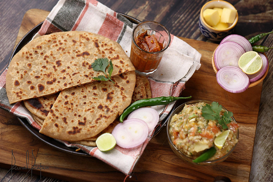 2pc sattu paratha with baigan chokha and chutney and pickle