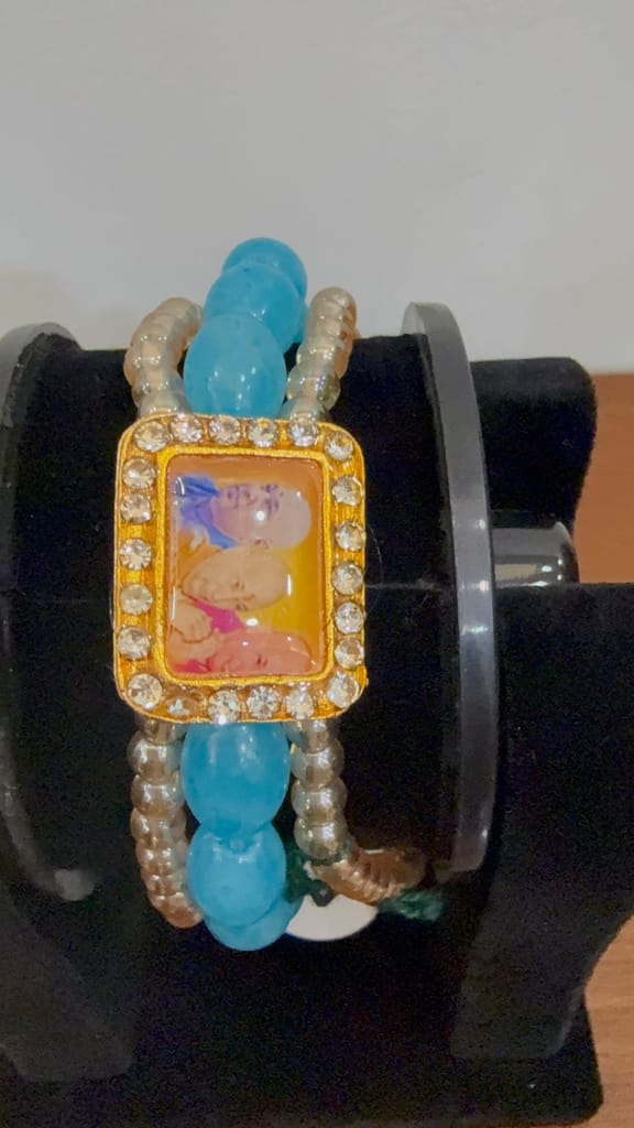 sacred unisex sky-blue moti pearl bracelet featuring a central guru ji photo