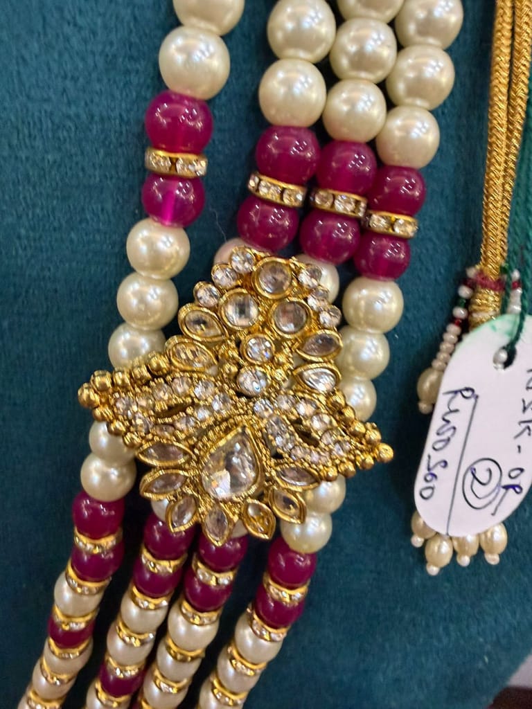 4 Strand pearl multi layer necklace featuring gold kundan side brooches and maroon beads view 2